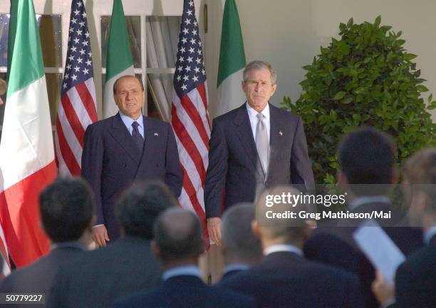 Visiting Italian Prime Minister Silvio Berlusconi and President Bush answering reporters questions during press conference in the Rose Garden of the...