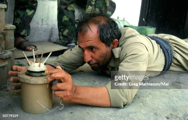 Kurdish peshmerga soldier demonstrating how to disarm a landmine.