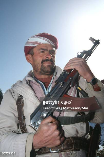 Kurdish peshmerga soldier standing guard outside the Headquarters of KDP Kurdish leader Musad Barzani atop a mountain overlooking Iraqi military...