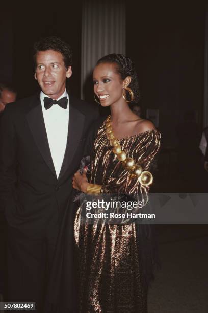 American fashion designer Calvin Klein and Somali fashion model Iman at the Met Gala, Metropolitan Museum of Art, New York City, USA, December 1981.