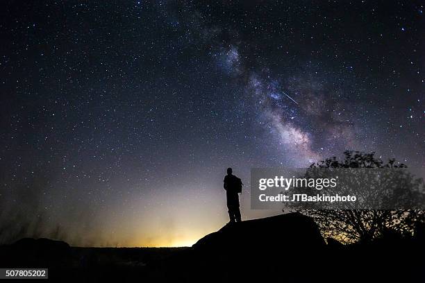 backpacker admiring the night sky - looking up at stars stock pictures, royalty-free photos & images