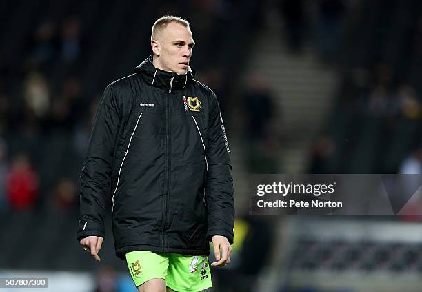 Cody Cropper of Milton Keynes Dons looks on as he warms up at half time during The Emirates FA Cup Fourth Round match between Milton Keynes Dons and...