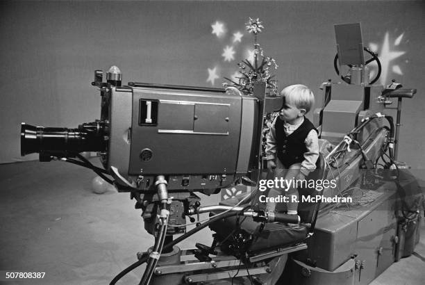 Mark Franks looks through a television camera in a television studio at the BBC Children's Party, 29th December 1964.