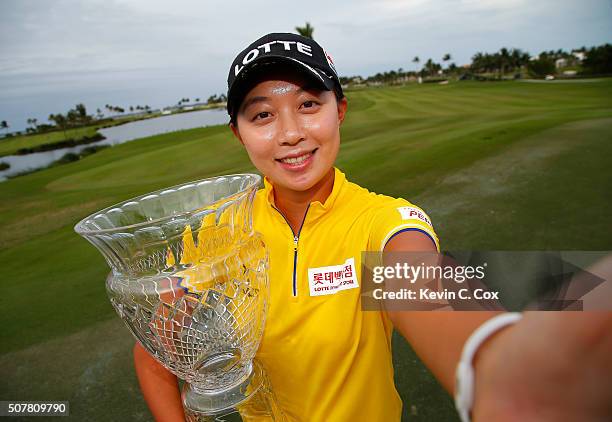 Hyo Joo Kim of South Korea pretends to take a selfie as she poses with the trophy after the final round of the Pure Silk Bahamas LPGA Classic at the...