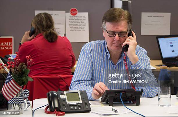 Texas Lieutenant Governor Dan Patrick makes phone calls as a volunteer for Republican presidential candidate Ted Cruz at his headquarters in West Des...