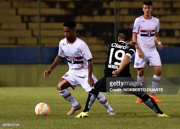 Paraguay's Libertad player Bruno Mendieta vies for the ball with Foguete of Brazil's Sao Paulo during their Copa Libertadores U20 football match at...