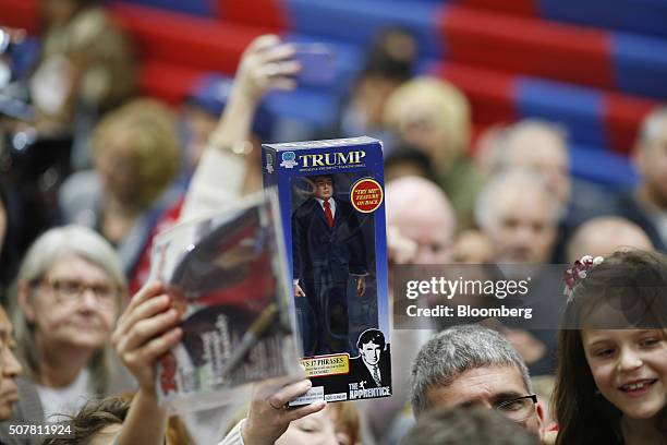 Attendee holds an action figure doll of Donald Trump, president and chief executive of Trump Organization Inc. And 2016 Republican presidential...