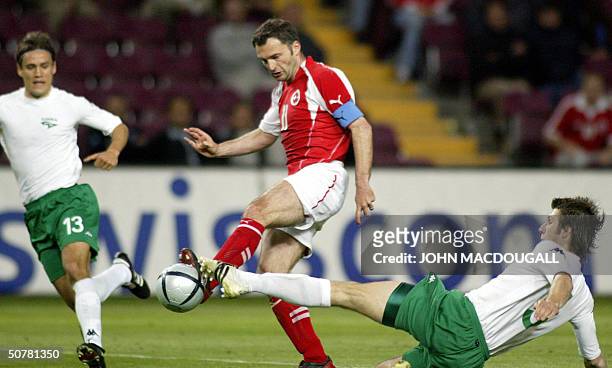 Switzerland's Stephane Chapuisat vies for the ball against Slovenia's Bostjan Cesar and Ales Kokot during their pre-Euro 2004 friendly match in...