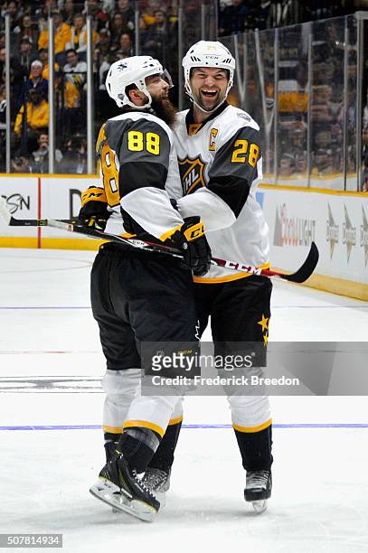 Brent Burns of the San Jose Sharks and John Scott of the Arizona Coyotes celebrate a goal during the Western Conference Semifinal Game between the...