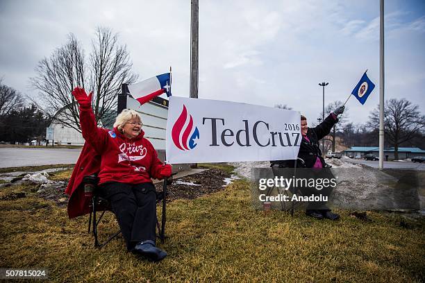 Melody Perez , from Texas, and Athena Perez , from Minnesota, wave to passing cars before a campaign rally for Republican Presidential Candidate Ted...
