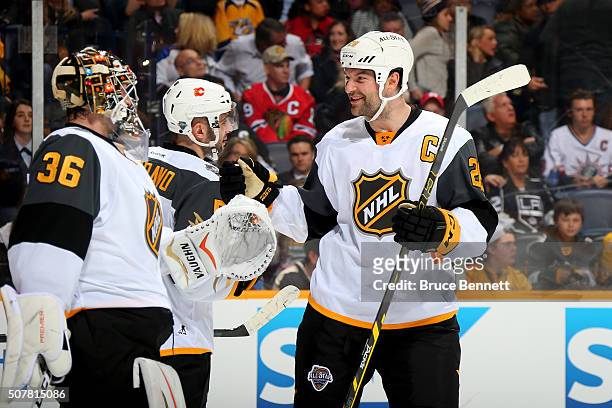 John Gibson of the Anaheim Ducks celebrates with John Scott of the Arizona Coyotes after defeating the Central Division All-Stars during the Western...