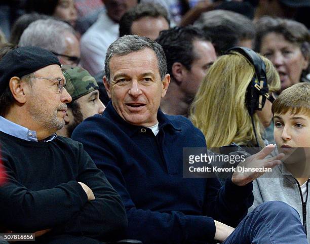 Bob Iger , chairman and chief executive officer of The Walt Disney Company, talks with actor Billy Crystal during the first half of the basketball...