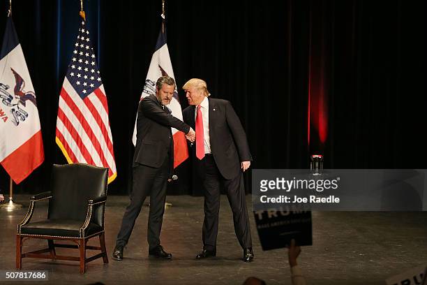 Jerry Falwell Jr. Greets Republican presidential candidate Donald Trump as he walks on stage during a campaign rally at the Sioux City Orpheum...