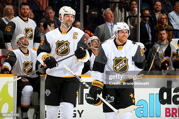 John Scott of the Arizona Coyotes and Joe Pavelski of the San Jose Sharks celebrate defeating the Central Division All-Stars during the Western...