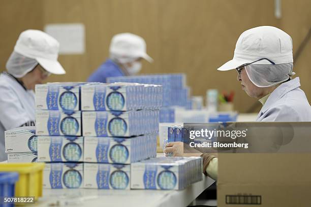 Employees arrange boxes of latex condoms for boxing at a Sagami Rubber Industries Co. Factory in Atsugi, Kanagawa Prefecture, Japan, on Thursday,...