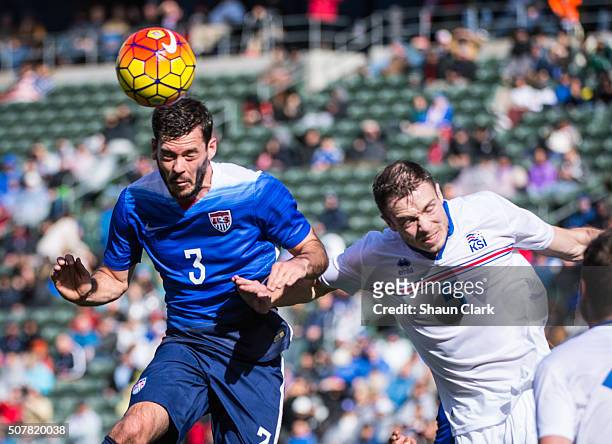 Brad Evans of the United States heads the ball toward goal as Jon Gudni Fjoluson of Iceland defends during the International Soccer Friendly match...