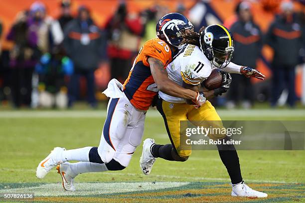 Chris Harris Jr. #25 of the Denver Broncos tackles Markus Wheaton during the game against the Pittsburgh Steelers at Sports Authority Field At Mile...