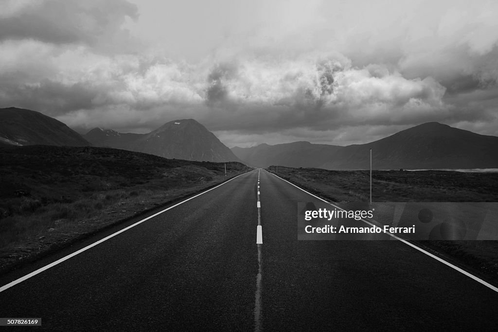 Black and white image of straight road and mountains, Scottish Highlands, Scotland