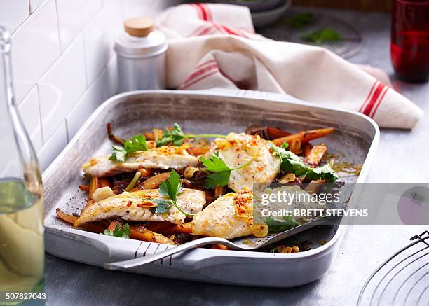 baking tin with roast snapper with herb garnish - schnapper stock-fotos und bilder