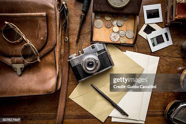 still life of group of vintage objects on table - coin photos stock-fotos und bilder