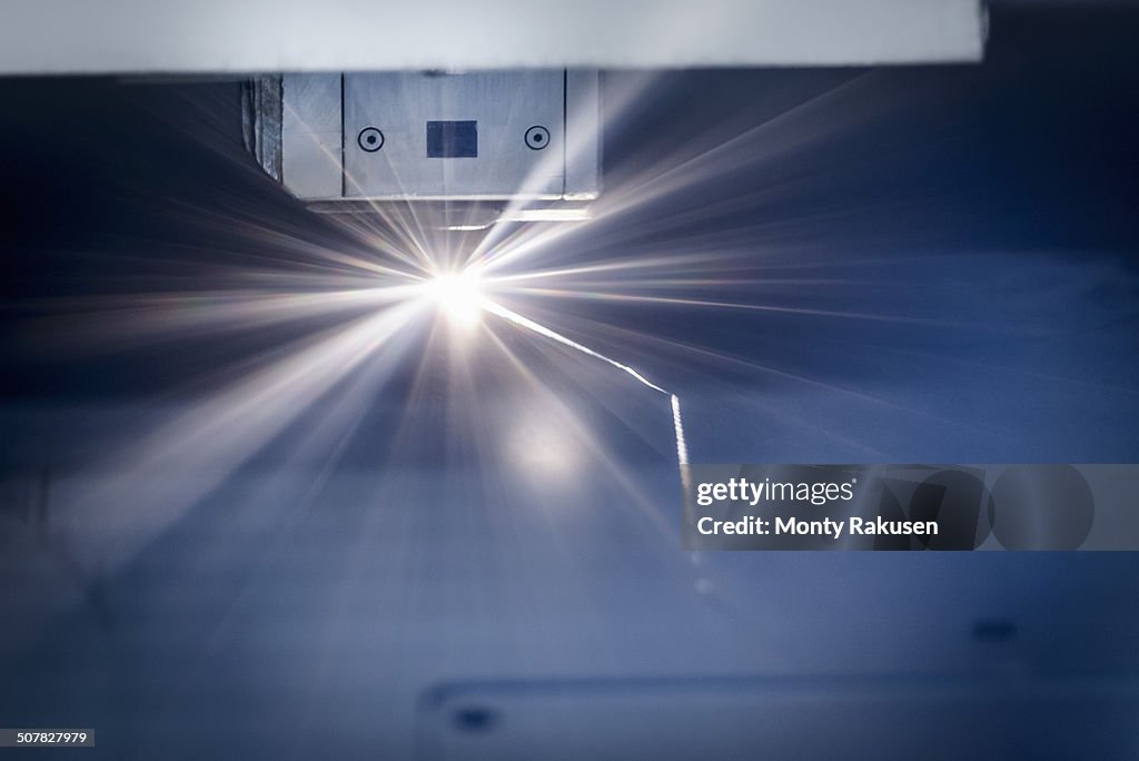 Laser cutter cutting metal in sheet metal factory
