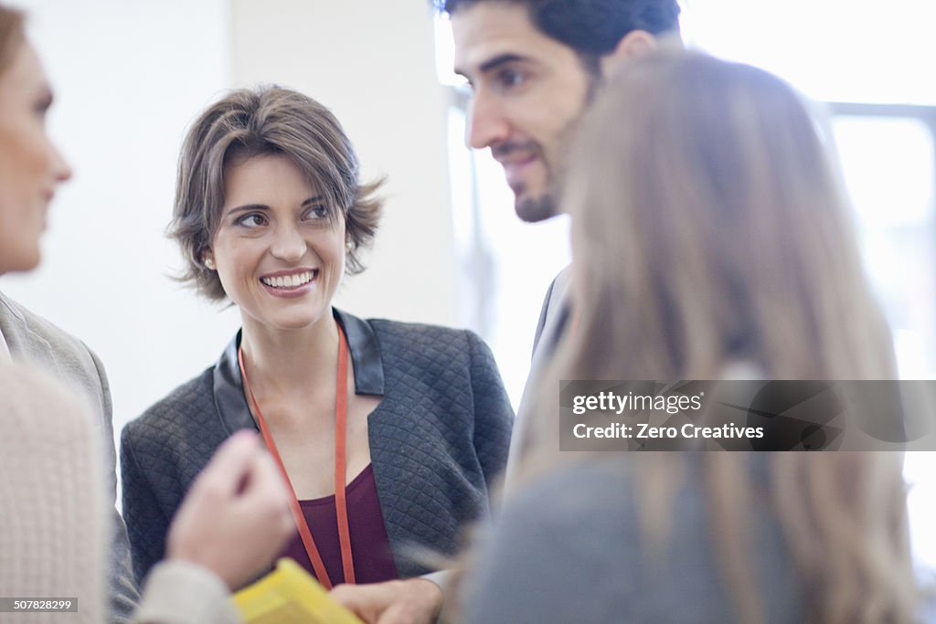 Businesswomen and businessman meeting in conference centre atrium