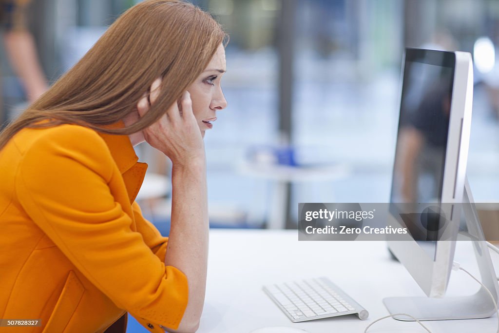 Female office worker staring at computer screen