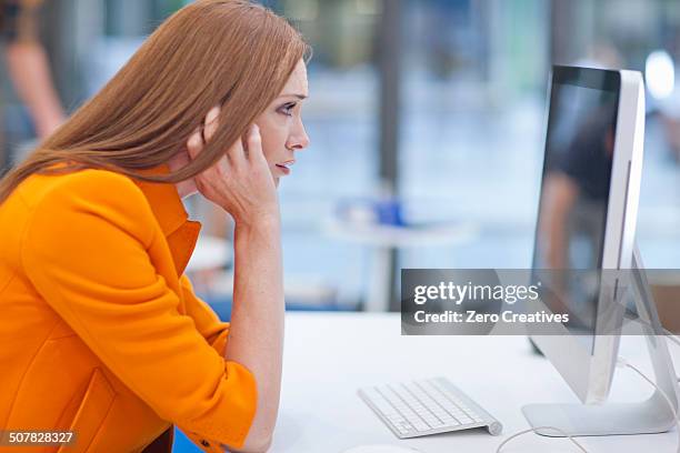 female office worker staring at computer screen - staring at screen stock pictures, royalty-free photos & images