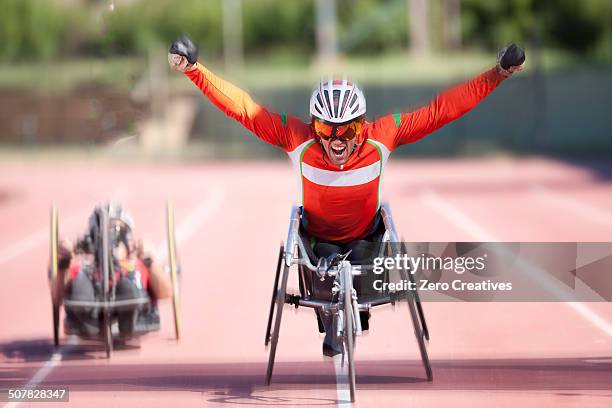 athlete at finishing line in para-athletic competition - disabled athlete stock pictures, royalty-free photos & images