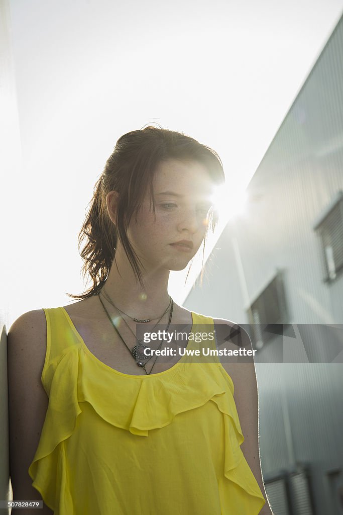 Young Sullen Girl In Yellow Blouse Gazing Down High-Res Stock Photo ...