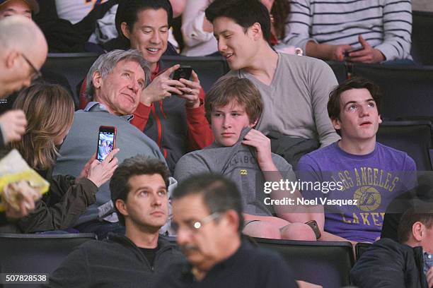 Calista Flockhart , Harrison Ford and Liam Flockhart attend a basketball game between the Charlotte Hornets and the Los Angeles Lakers at Staples...