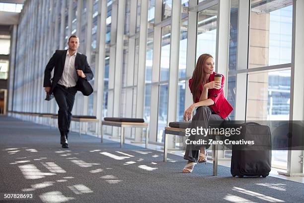 businessman running along conference centre corridor - cape town airport stock pictures, royalty-free photos & images