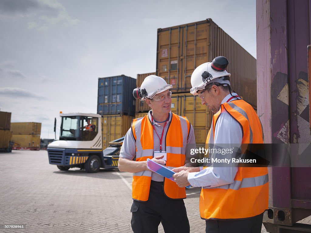 Port workers and shipping containers in port