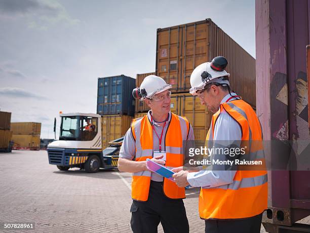 port workers and shipping containers in port - transportation occupation stock pictures, royalty-free photos & images