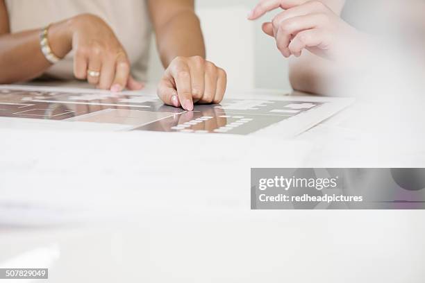 cropped shot of two businesswomen's hands and blueprint - close up of blueprints stock pictures, royalty-free photos & images