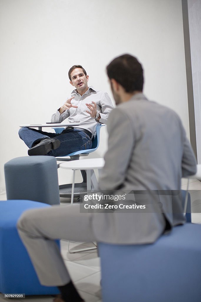 Male colleagues talking in office