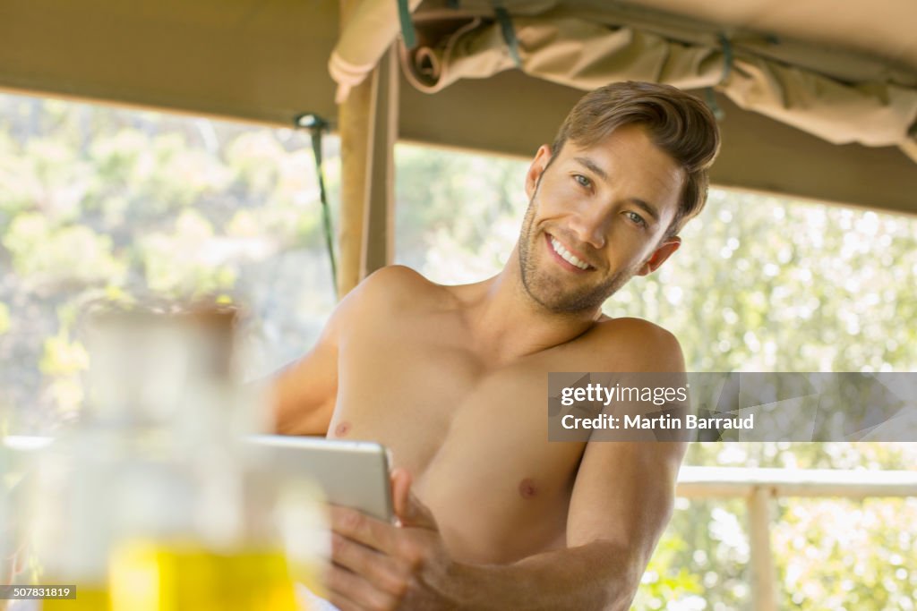 Man using digital tablet on balcony
