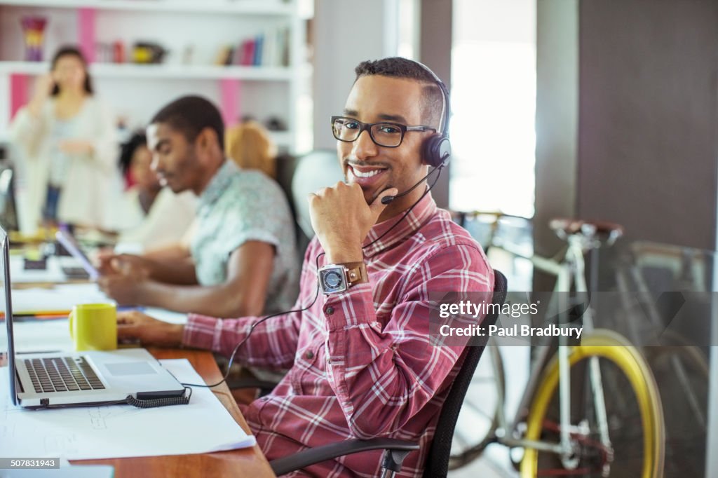 Man smiling at desk in office