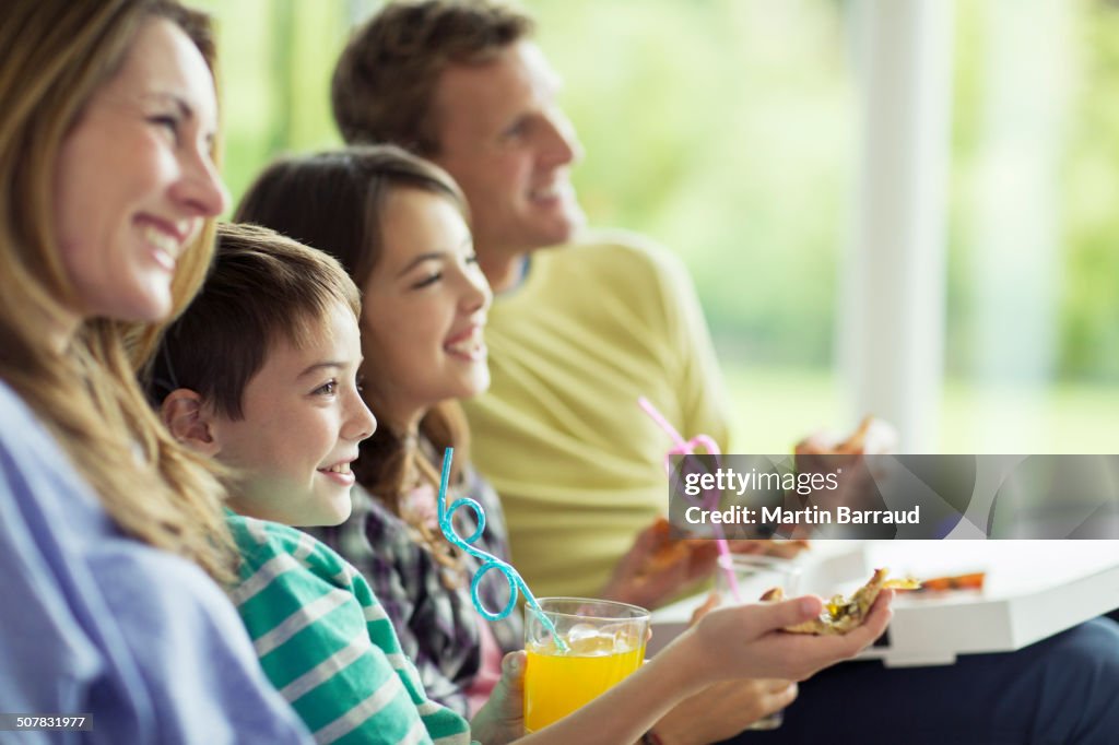 Family watching television in living room