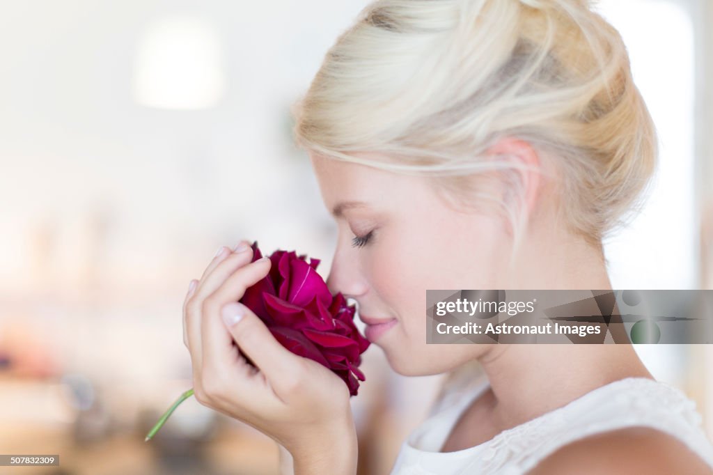 Woman smelling rose