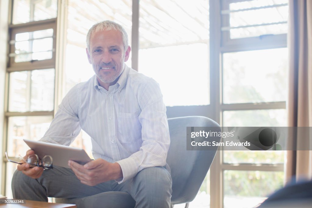 Businessman using digital tablet in living room