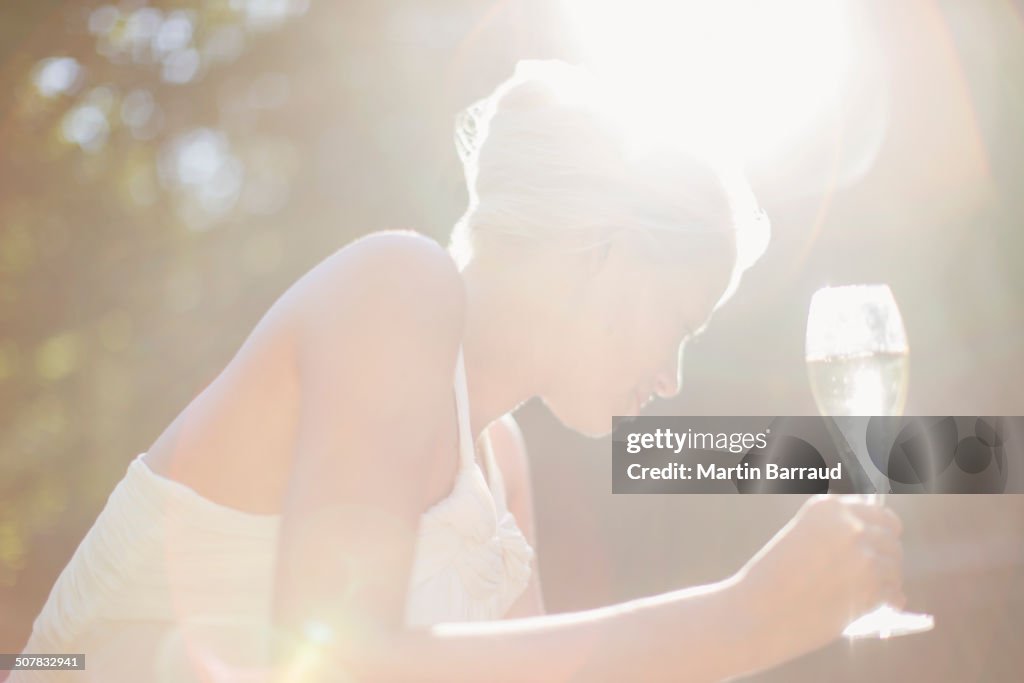 Woman drinking champagne outdoors