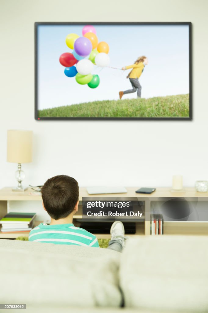 Boy watching television in living room