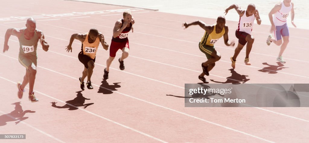 Runners racing on track