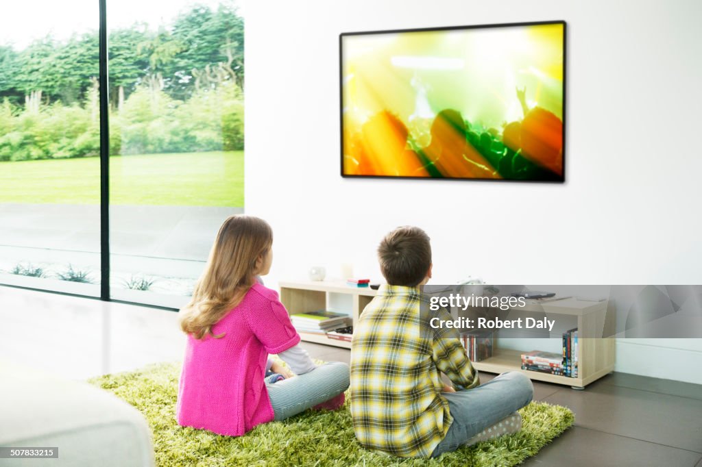 Children watching television in living room