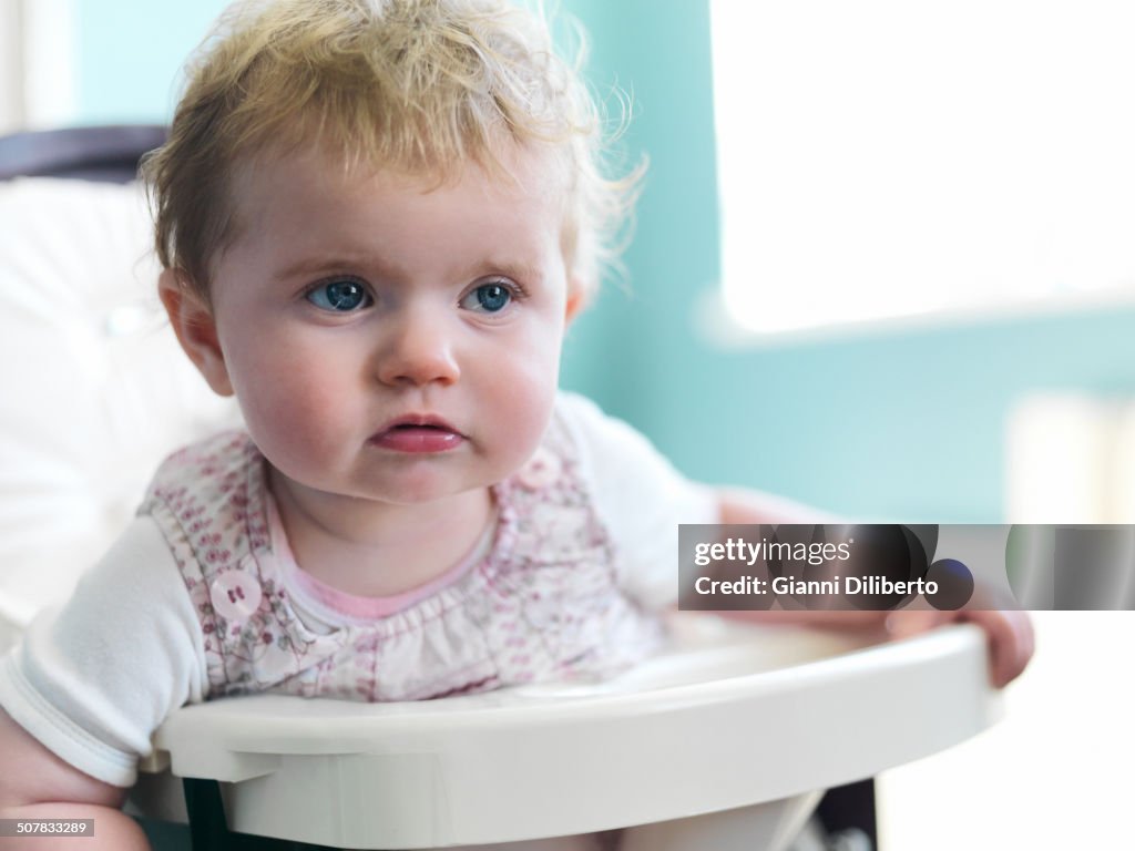 Girl sitting in high chair