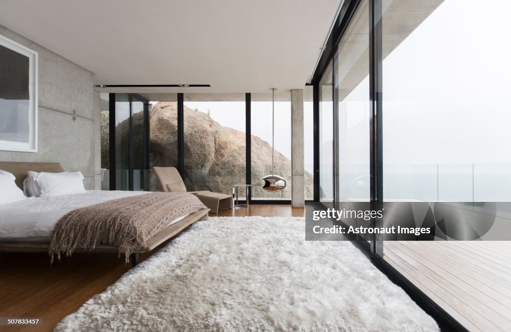 Shag rug and glass walls in modern bedroom