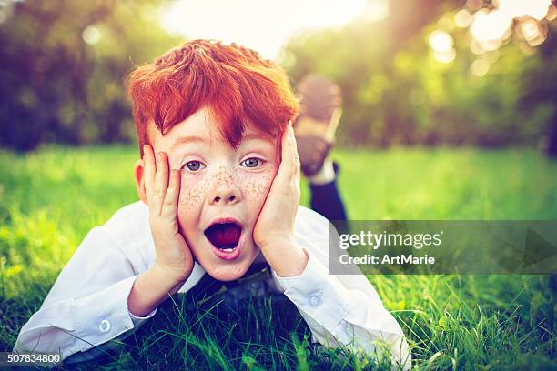redhead boy outdoors - natural disaster stockfoto's en -beelden