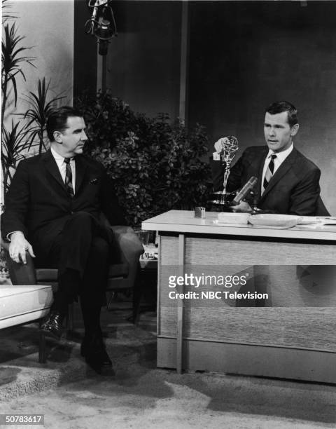 Host Johnny Carson sits with an Emmy award on his desk, as announcer Ed McMahon looks on, in a still from 'The Tonight Show With Johnny Carson,' 1963.