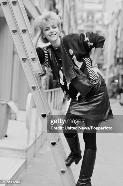 English actress Leslie Ash posed standing on a ladder in London on 13th October 1983.